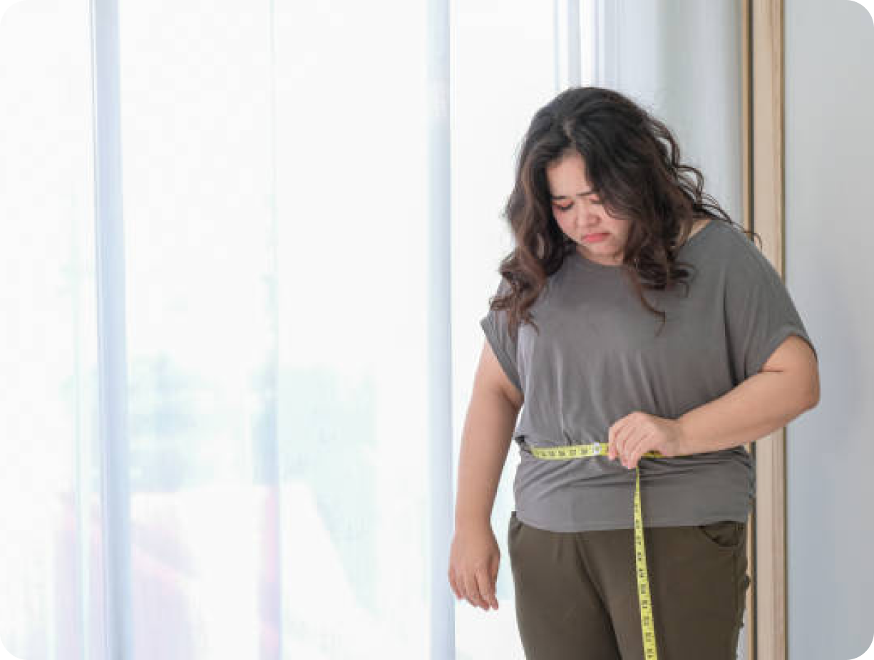 Disappointed woman with measuring tape around waist